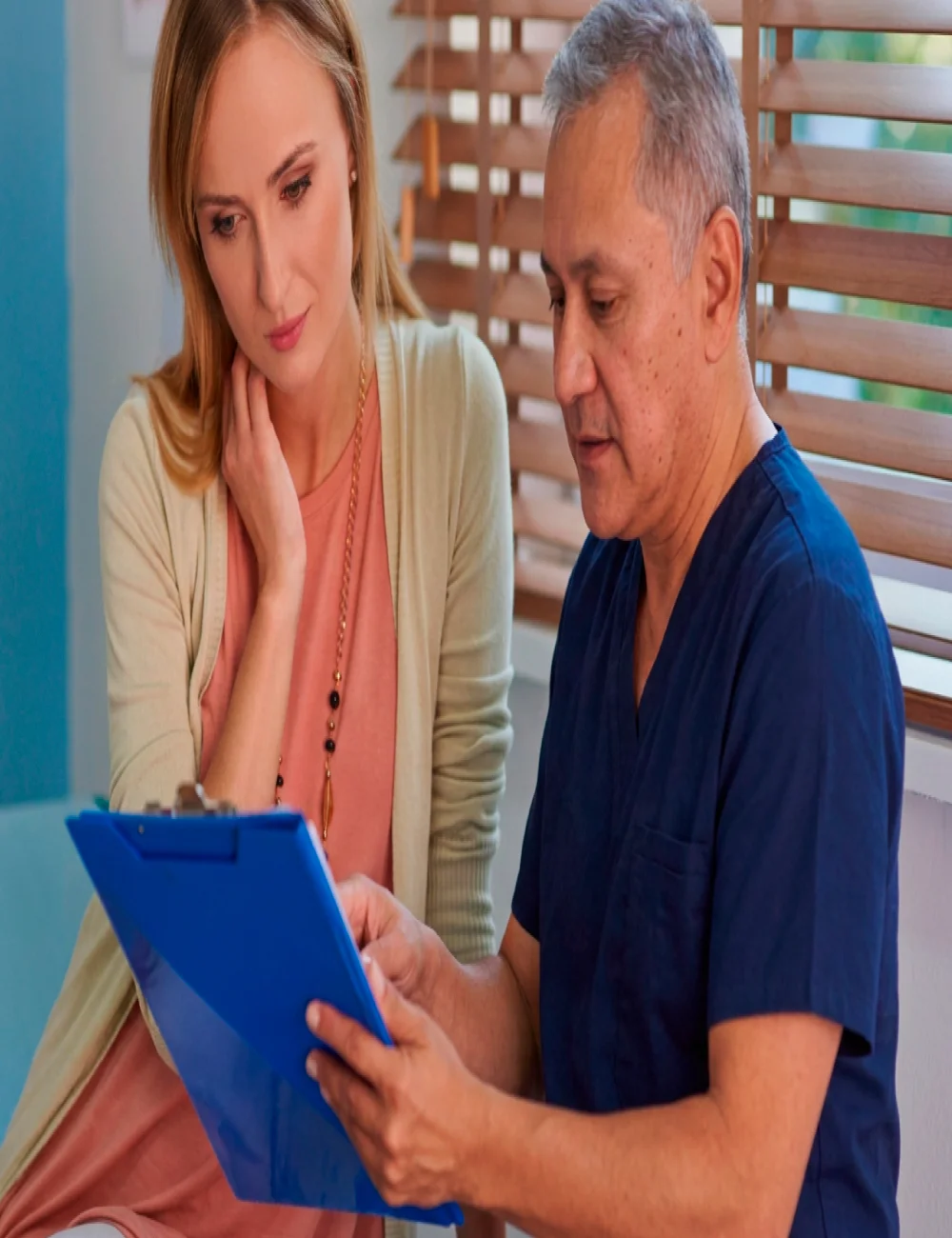 Chiropractor reviewing a patient's health history during an evaluation